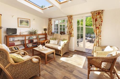 a living room filled with furniture and a window at Jacobs Pond Monksilver in Stogumber