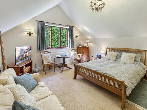 a bedroom with a large bed and a couch at Bridlecott Monksilver in Monksilver