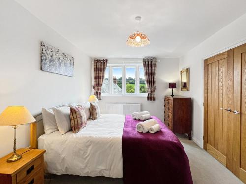 a bedroom with a bed and a window at Meadow View Brushford in Dulverton