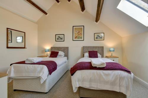 two beds in a room with a attic at Yenworthy Mill Countisbury in Countisbury