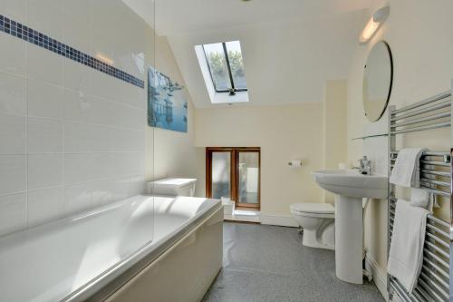 a bathroom with a tub and a sink and a toilet at Yenworthy Mill Countisbury in Countisbury
