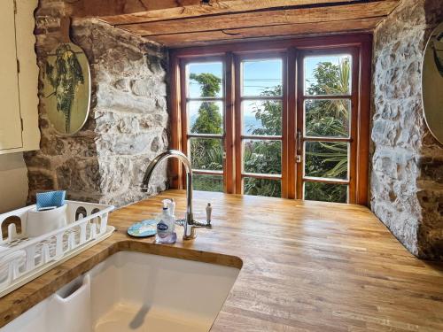a kitchen with a sink and a large window at The Crows Nest Porlock Weir in Porlock