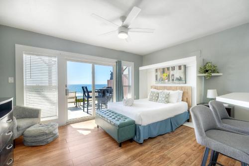 a bedroom with a bed and a view of the ocean at Oceanfront Condo, Private Patio, Beach Access, Sunset Views in Carlsbad