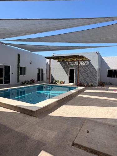 a large swimming pool in a building with a pavilion at Los Agaves Lto in Loreto