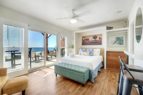 a bedroom with a bed and a view of the ocean at Oceanfront Condo, Private Patio, Beach Access, BBQ in Carlsbad