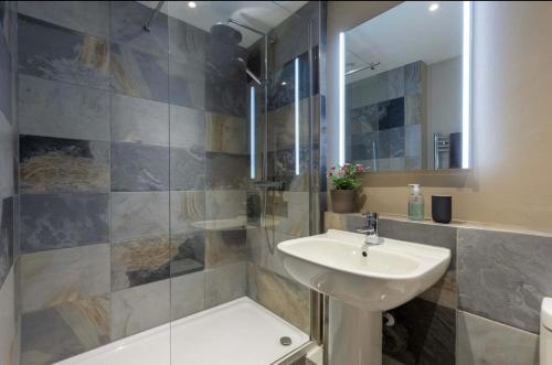 a bathroom with a sink and a shower at The Piggery Dulverton in Dulverton