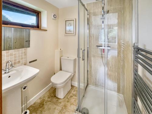 a bathroom with a toilet and a glass shower at Ormrods Withypool in Withypool