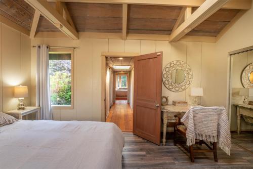 a bedroom with a bed and a table and a mirror at Lighthouse in Little River