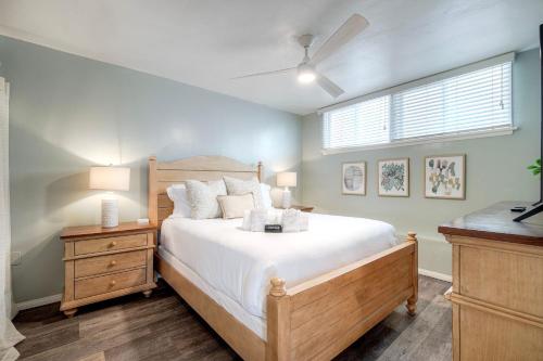 a bedroom with a large bed and a window at Oceanfront Apartment, Private Balcony, Beach Access, Sunset Views in Carlsbad