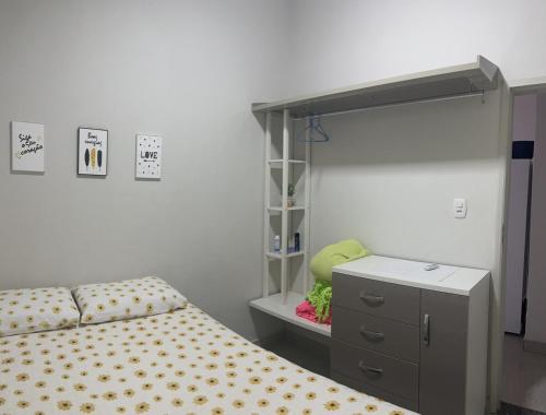 a bedroom with a bed and a dresser and a mirror at Casa com ampla área externa de lazer in São Luís