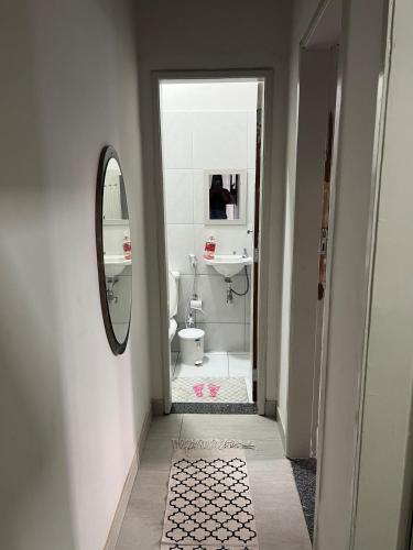 a bathroom with a sink and a toilet and a mirror at Casa com ampla área externa de lazer in São Luís