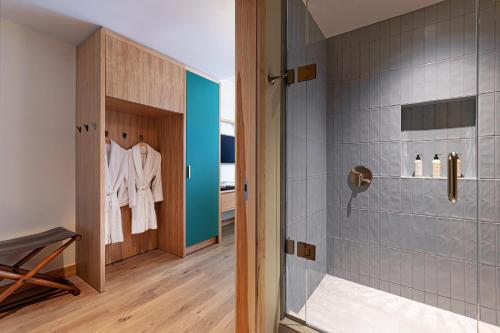 a bathroom with a shower with a glass door at The Compton in Bentonville
