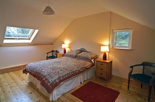 a bedroom with a bed and two windows at 2 Bed in Maam oc-i252 in Claggan