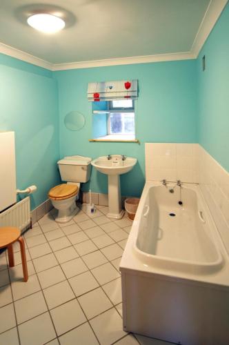 a bathroom with a tub and a toilet and a sink at 2 Bed in Maam oc-i252 in Claggan