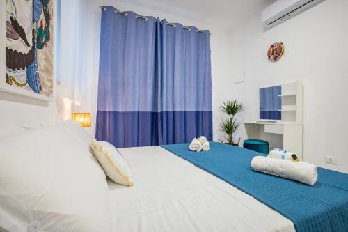 a bedroom with a bed with two stuffed animals on it at Kai Loft & Suite - By the Sea in Giardini Naxos