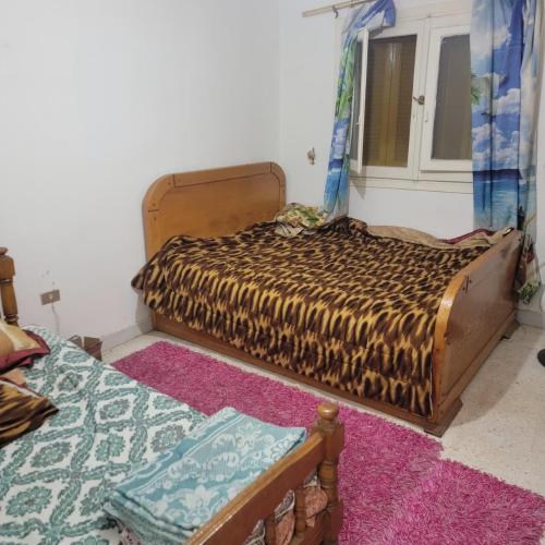 a bedroom with two beds and a window at A ROOM in mandara in Alexandria