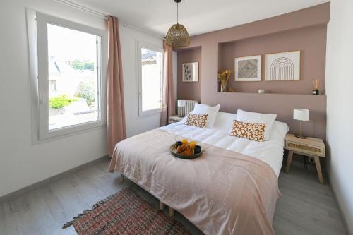 a bedroom with a bed with a bowl of fruit on it at La Belle Droite in Le Havre