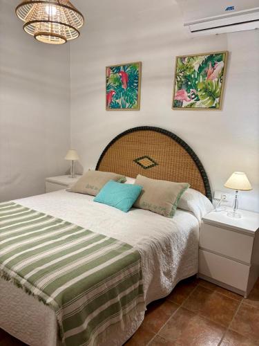 a bedroom with a large bed and two night stands at Chalet Eucaliptus in Alcossebre