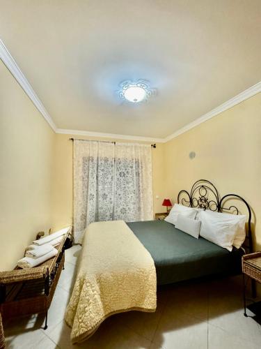 a bedroom with a large bed and a window at Renaissance Sunrise Inn Algarve in Portimão