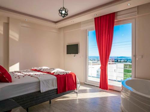 a bedroom with a bed and a large window at Villa adelina in Çavdır