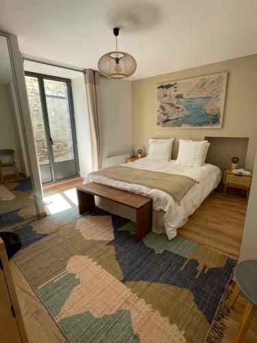 a bedroom with a large bed and a large rug at L'escapade Saint Michel in Val Couesnon