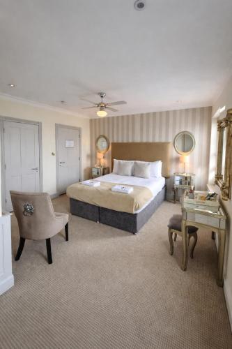 a large bedroom with a large bed and a table at Crescent Victoria Hotel in Margate