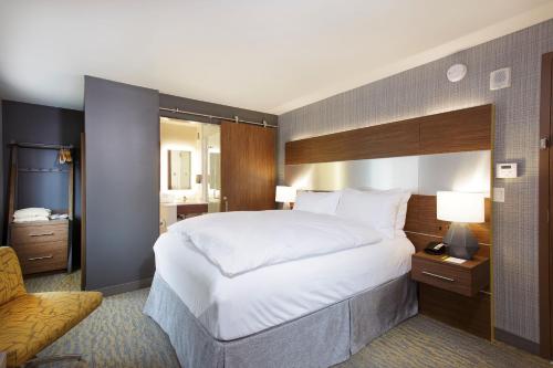 a hotel room with a large bed and a bathroom at Hotel Z - Gaslamp San Diego in San Diego