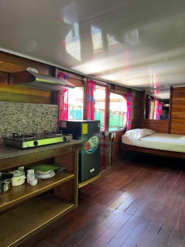 a room with a kitchen and a bed in a bus at Rocking J's in Puerto Viejo