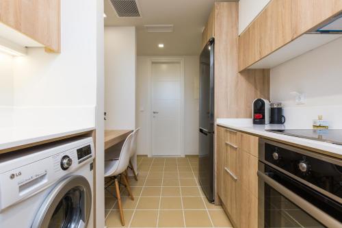 a laundry room with a washer and dryer at Mikro Livadi Special Lodges - Has an Eco Salt water pool - 150m from the beach in Episkopí- Rethimno