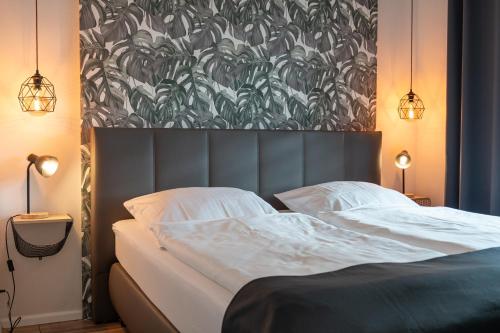 a bedroom with a large bed with a large headboard at Apartment Enjoy in Büsum