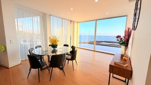 a dining room with a table and chairs and the ocean at Marina Mar II Premium in Vila Franca do Campo