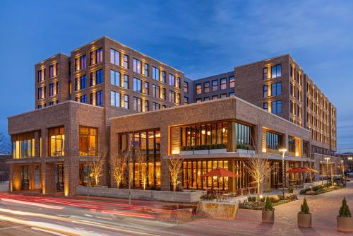 a large building on a city street at night at The Compton in Bentonville