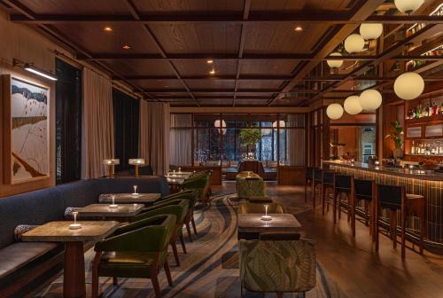 a restaurant with tables and chairs and a bar at The Compton in Bentonville