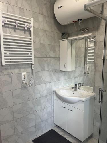 a white bathroom with a sink and a mirror at Apartment Boro in Selce