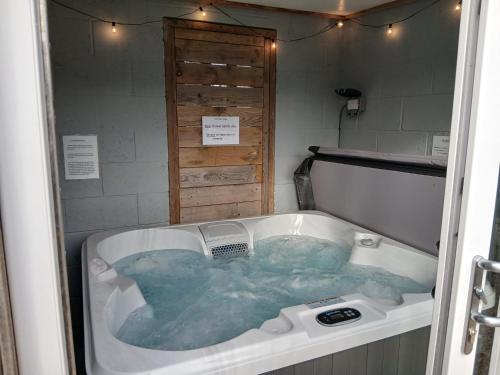 a jacuzzi tub in a room with at The Sunset "with private Hot tub" in Worth