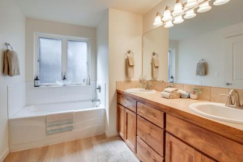 a bathroom with a tub and a sink at Spacious Bandon Getaway - 2 Blocks to Ocean! in Bandon