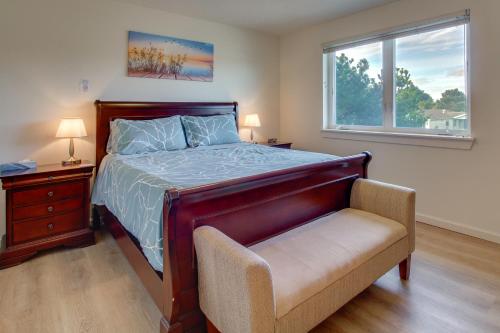 a bedroom with a bed and a chair and a window at Spacious Bandon Getaway - 2 Blocks to Ocean! in Bandon