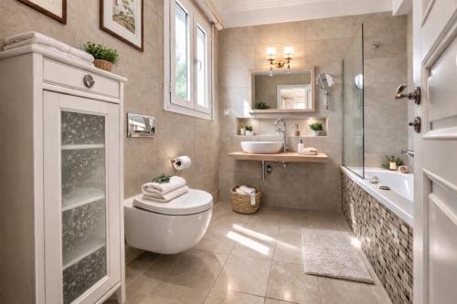 a bathroom with a toilet and a sink at Villa Olea Corfu - Private Pool & Panoramic Views in Perama