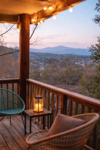 a porch with a table and chairs and a candle at The Sanctuary Company Johnson City in Johnson City