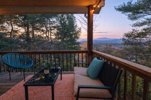 a porch with a couch and a table on a deck at The Sanctuary Company Johnson City in Johnson City