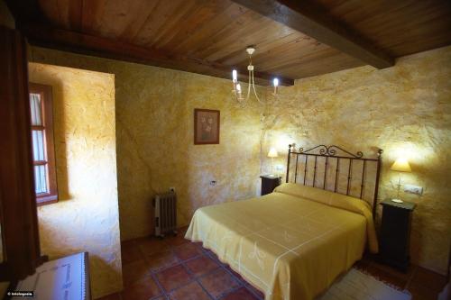 a bedroom with a bed in a stone wall at La Estancia in El Bosque