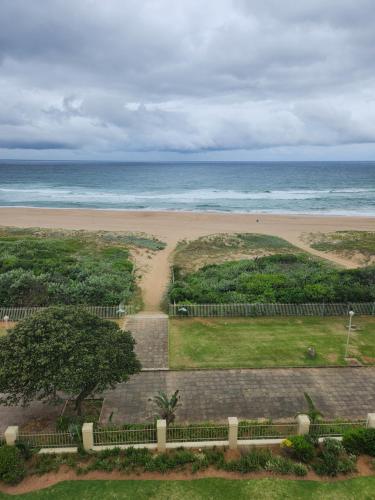 a view of the beach and the ocean at Lescalier 513 Luxury sea facing unit in Amanzimtoti