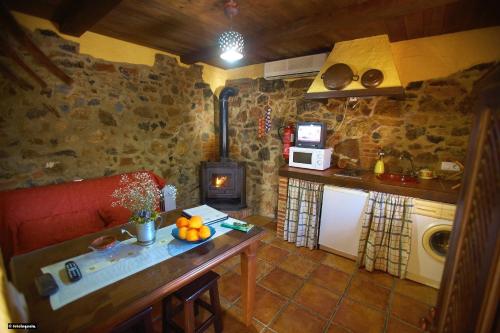 a small kitchen with a table and a stove at La Estancia in El Bosque