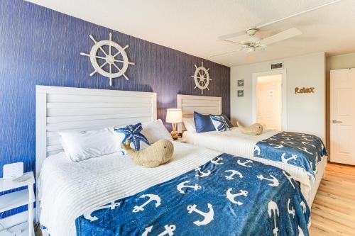 two beds with teddy bears on them in a bedroom at Beachfront! Indian Rocks Beach Condo w/ Balcony in Clearwater Beach