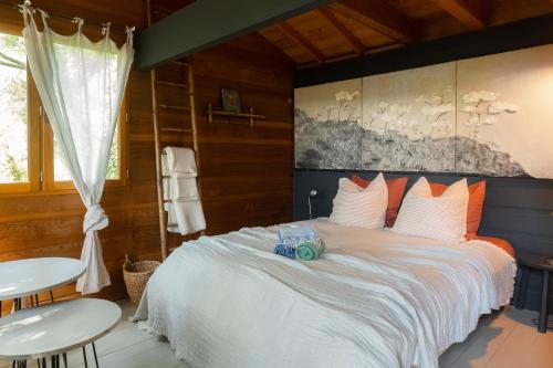 a bedroom with a large bed and two tables at Orion Treehouses in Saint Paul de Vence