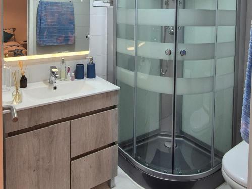 a bathroom with a shower and a sink at Spacious Bright Apartament with Ocean Views in Caniço
