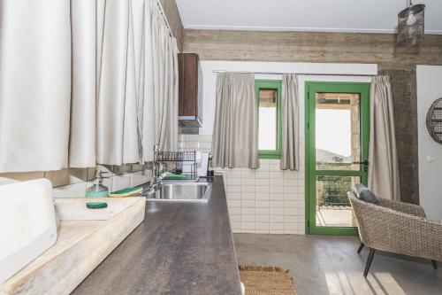 a kitchen with a sink and a counter at GAIA - Boutique Retreat in Marathopoli