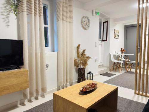 a living room with a tv and a table at The Central Retreat 1 in Mytilene
