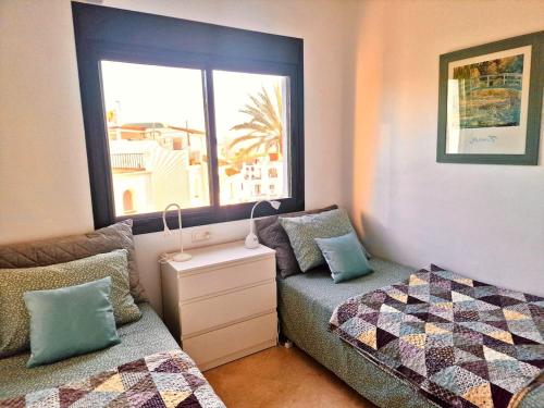 a small bedroom with a bed and a window at Casa Tranquila La Duquesa in Manilva