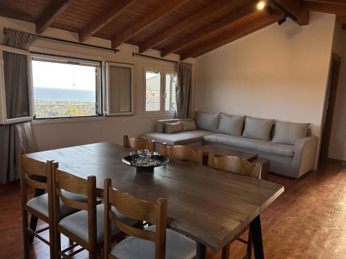 a living room with a wooden table and a couch at Stavroula's House in Argyrádes
